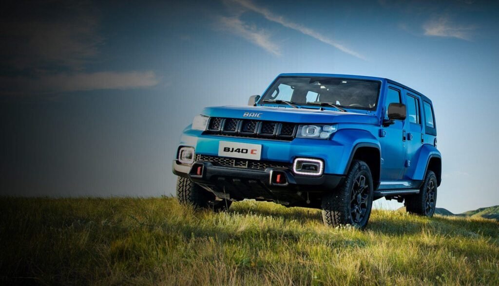 Blue BAIC BJ40 Plus off-road SUV on open grassland